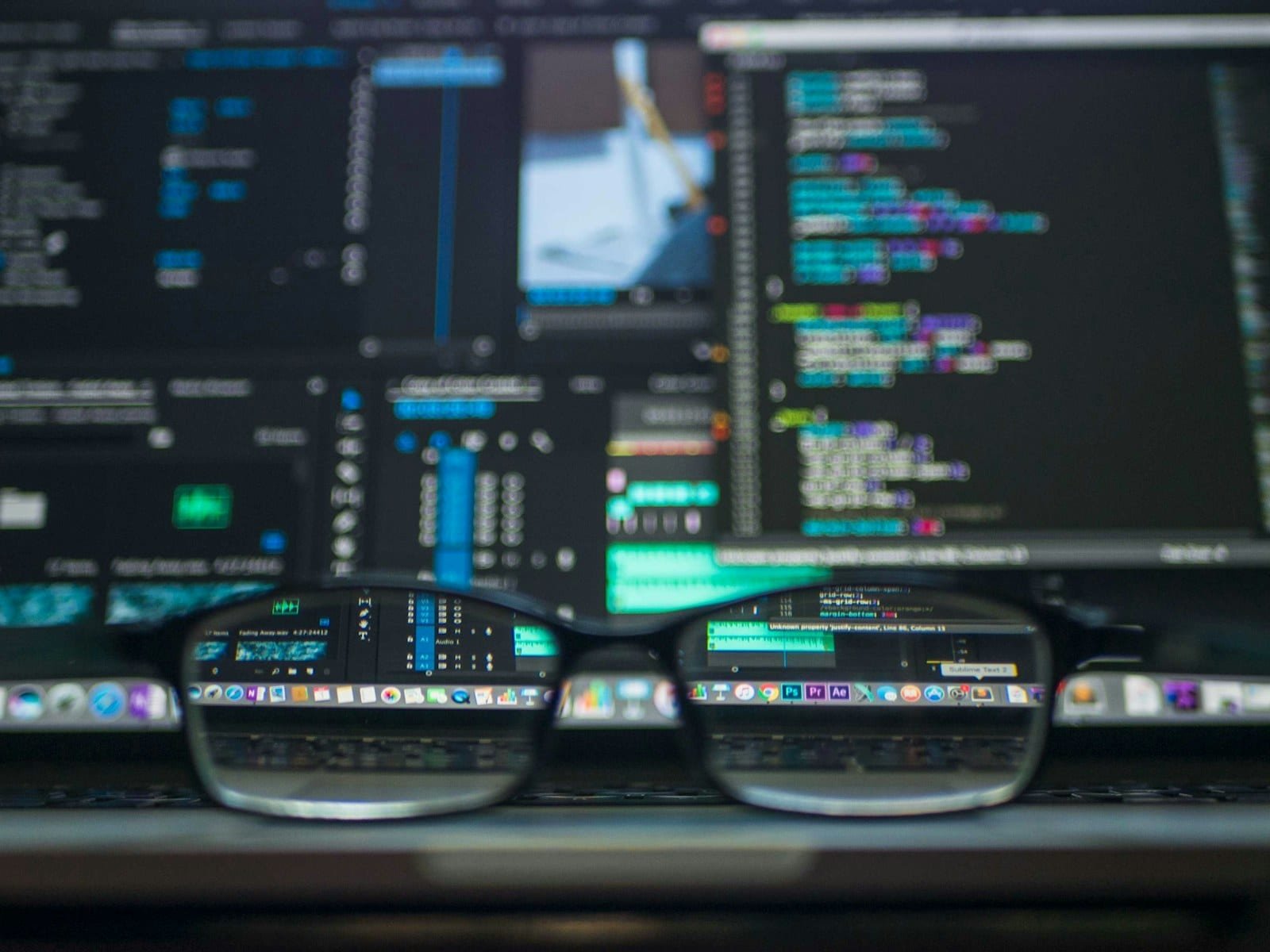 Glasses in front of code on screen