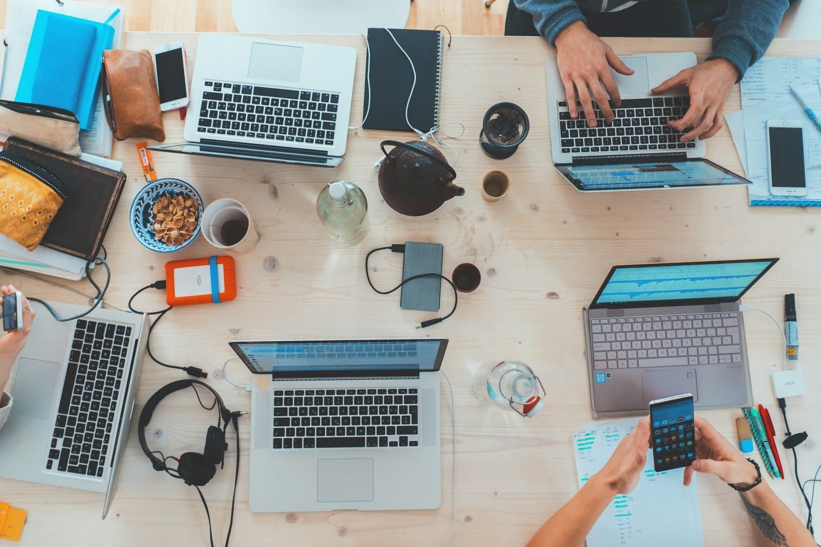 Team working on laptops at a shared desk